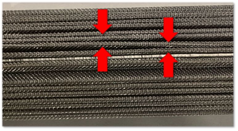Example of media sleeve pinching in a metal candle filter used for high-viscosity polymer processing