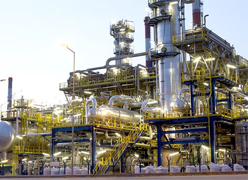 Personnel inspecting steam cracker process equipment at an ethylene production facility.
