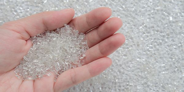 plastic recycling and clear polymer granules on a conveyor belt